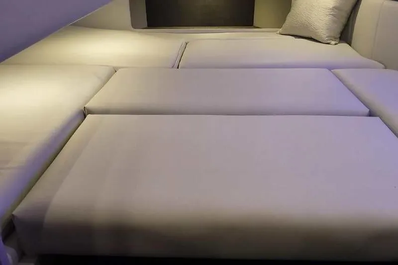 Slide: The Image of 2024 Formula 330 Crossover Bowrider I/O interior cabin with plush seating and ambient lighting. - 46