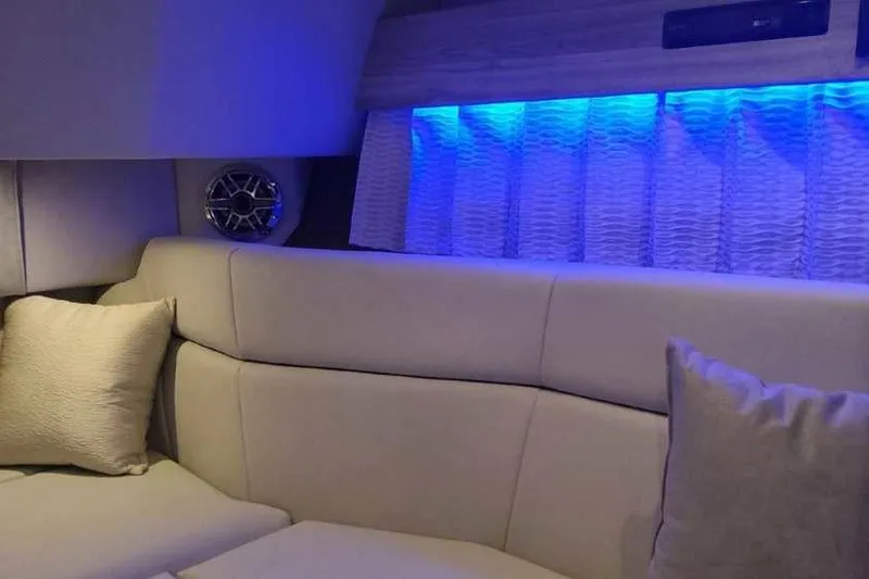 Slide: The Image of Luxurious interior of 2024 Formula 330 Crossover Bowrider I/O with blue LED lighting. - 47
