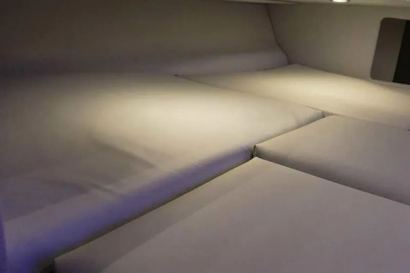 Slide: The Image of 2024 Formula 330 Crossover Bowrider I/O cabin interior with cushioned seating. - 48