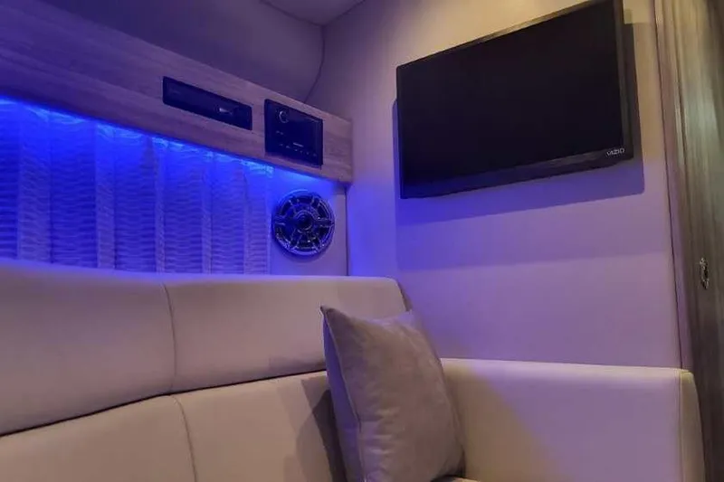 Slide: The Image of 2024 Formula 330 Crossover Bowrider I/O interior with blue LED lighting and TV. - 49