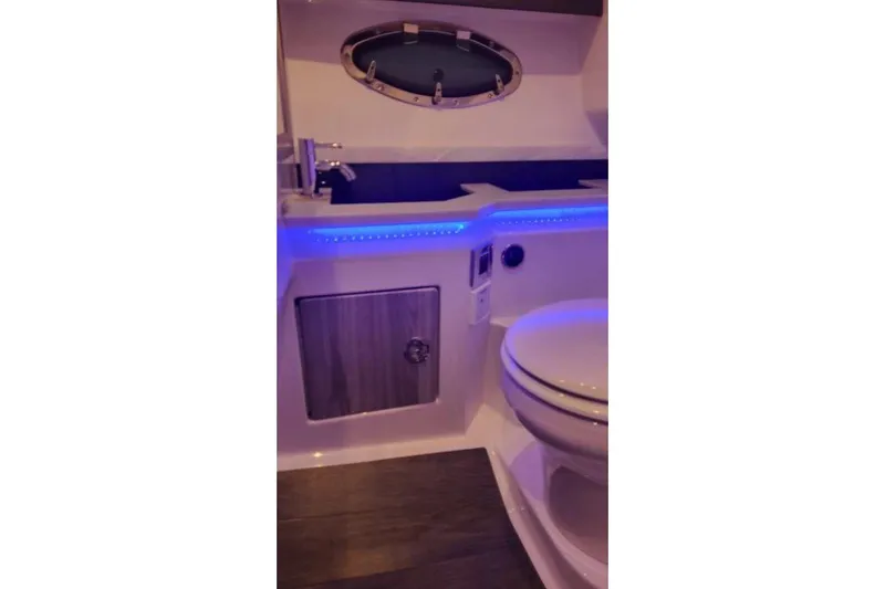 Slide: The Image of 2024 Formula 330 Crossover Bowrider I/O bathroom with modern fixtures and ambient lighting. - 51