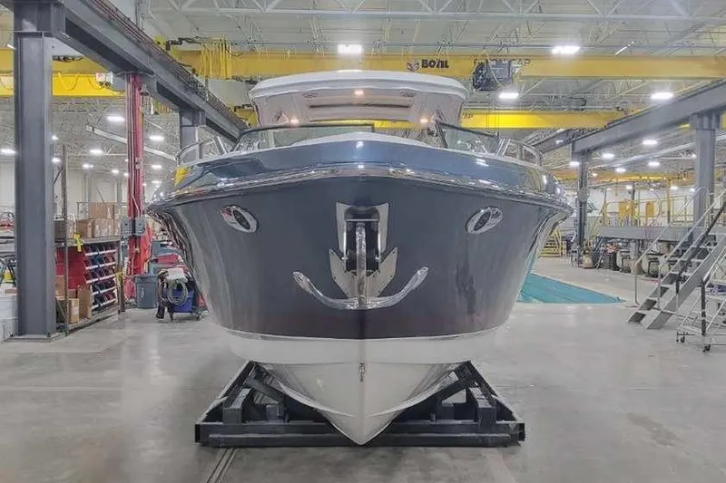 Slide: The Image of 2024 Formula 330 Crossover Bowrider I/O in a factory setting, front view. - 6