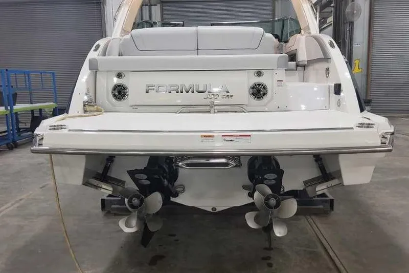 Slide: The Image of 2024 Formula 330 Crossover Bowrider I/O, rear view in a garage setting. - 7