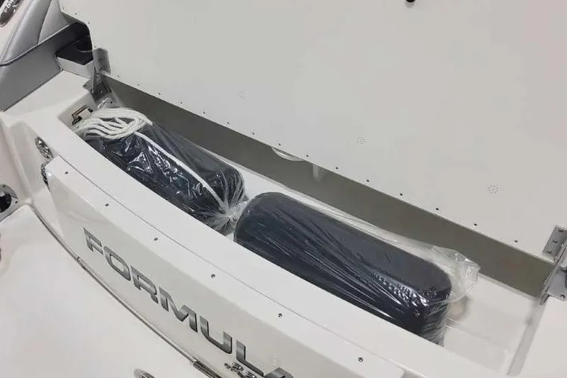 Slide: The Image of 2024 Formula 330 Crossover Bowrider I/O storage compartment with packaged accessories. - 9