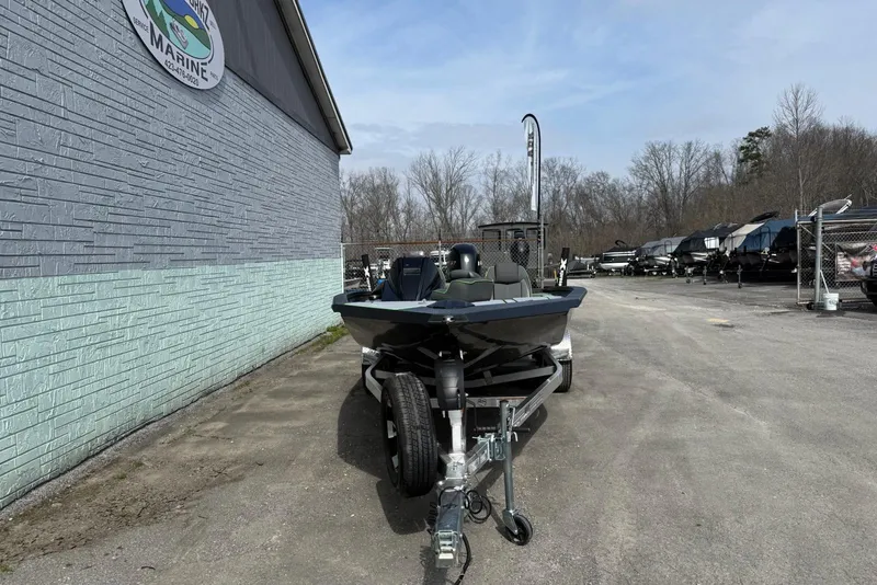 Slide: The Image of 2026 Xpress H20 Bass boat on trailer outside marine dealership. - 3