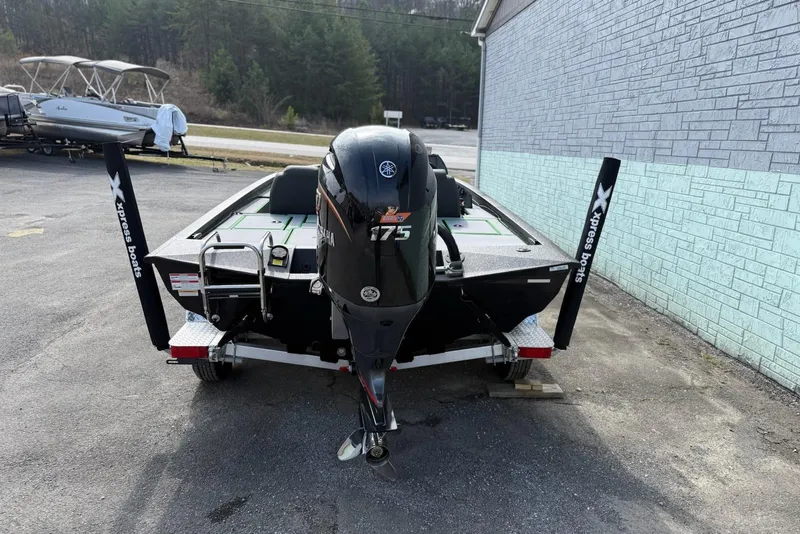 Slide: The Image of 2026 Xpress H20 Bass boat with Yamaha 175 engine, parked on a trailer. - 4