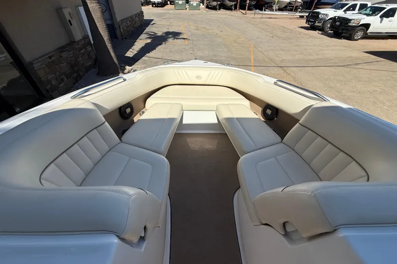 Slide: The Image of 2009 Cobalt 242 boat interior with beige seating and spacious layout. - 12