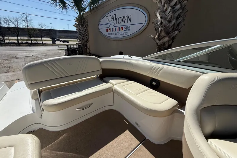 Slide: The Image of 2009 Cobalt 242 boat interior with beige seating at Boat Town dealership. - 14