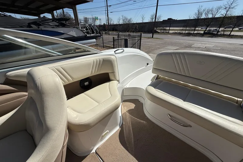 Slide: The Image of 2009 Cobalt 242 boat interior with beige seating and sleek design. - 15