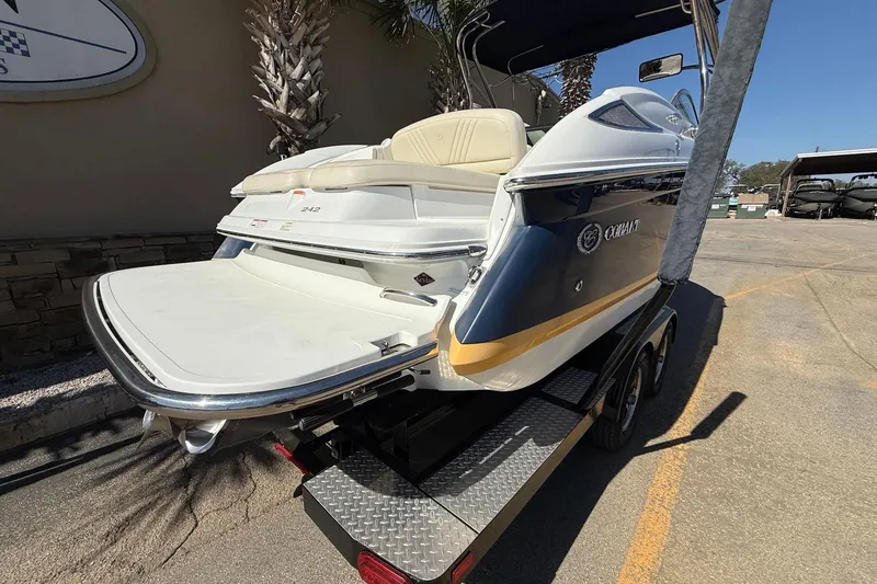 Slide: The Image of 2009 Cobalt 242 boat on trailer, rear view, showcasing swim platform and seating. - 5