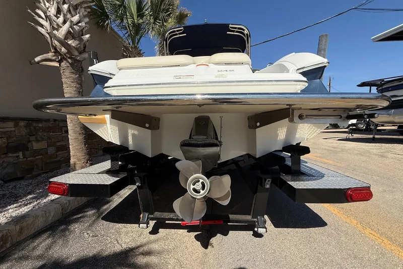 Slide: The Image of Rear view of a 2009 Cobalt 242 boat on a trailer, showcasing propeller and hull. - 6
