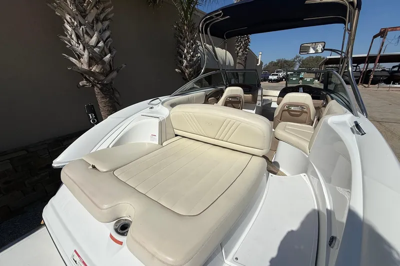 Slide: The Image of 2009 Cobalt 242 boat interior with beige seating and sleek design. - 8