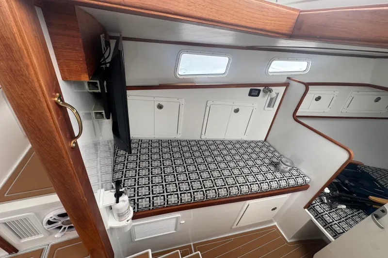 Slide: The Image of Interior of 2000 Northern Bay 38 boat with patterned seating and wooden accents. - 11