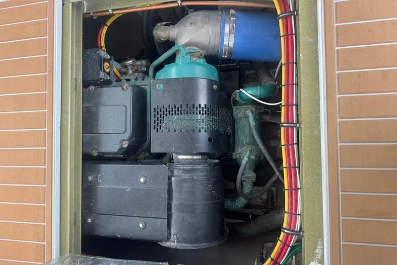 Slide: The Image of Engine compartment of a 2000 Northern Bay 38 boat, showcasing mechanical components and wiring. - 20