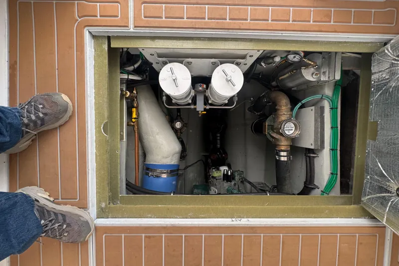 Slide: The Image of Engine compartment of a 2000 Northern Bay 38 boat, showing mechanical components and deck. - 21