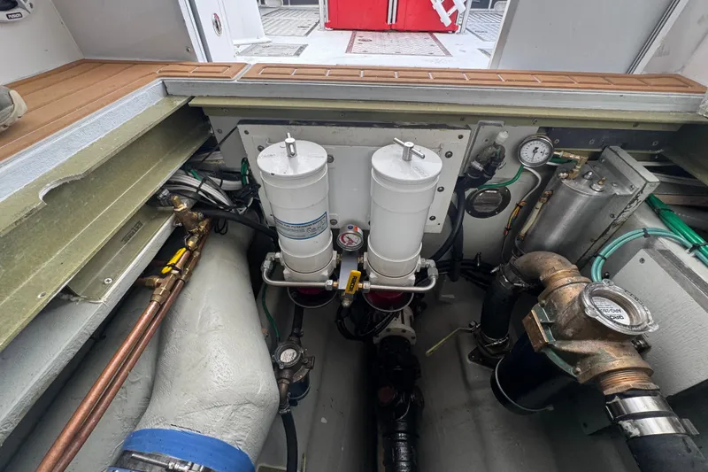 Slide: The Image of Engine compartment of a 2000 Northern Bay 38, showcasing filters and gauges. - 22