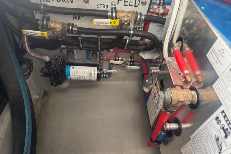 Slide: The Image of Engine room of a 2000 Northern Bay 38, showcasing plumbing and mechanical components. - 23