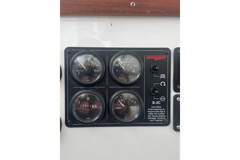Slide: The Image of Instrument panel of a 2000 Northern Bay 38 Northern Bay boat, featuring gauges and controls. - 24