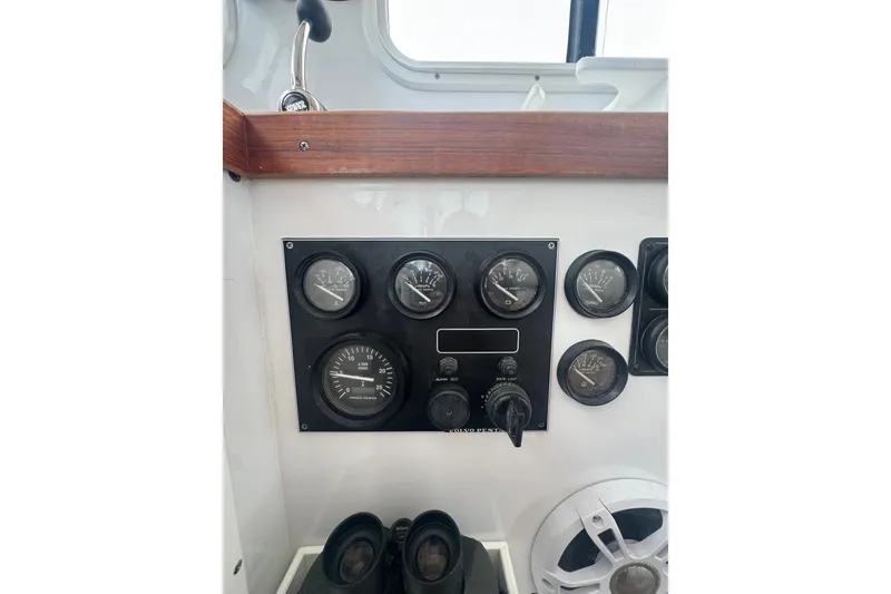 Slide: The Image of Control panel of a 2000 Northern Bay 38 boat with gauges and switches. - 25