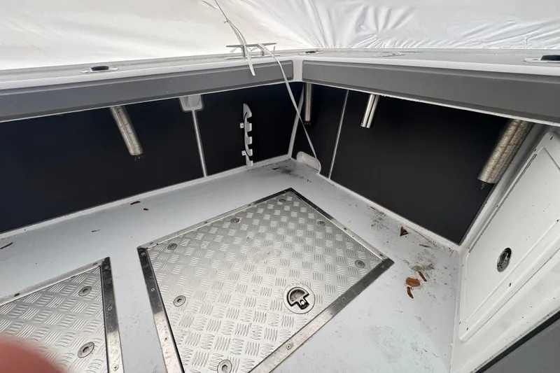 Slide: The Image of Interior view of a 2000 Northern Bay 38 boat, featuring metal flooring and storage compartments. - 26