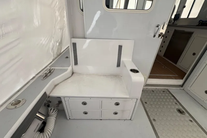 Slide: The Image of Interior of a 2000 Northern Bay 38 boat, featuring seating and storage compartments. - 28