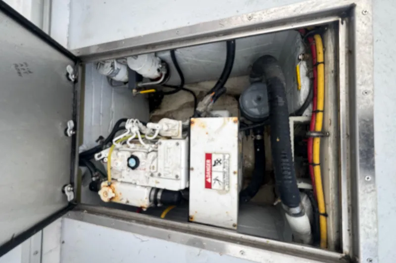 Slide: The Image of Engine compartment of a 2000 Northern Bay 38 boat, showing mechanical components and wiring. - 29