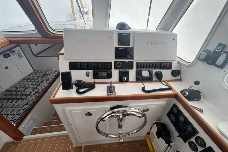 Slide: The Image of Cockpit of 2000 Northern Bay 38, featuring navigation equipment and steering wheel. - 5