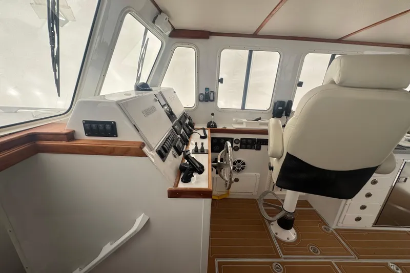 Slide: The Image of Interior helm of 2000 Northern Bay 38 boat with modern controls and captain's chair. - 6