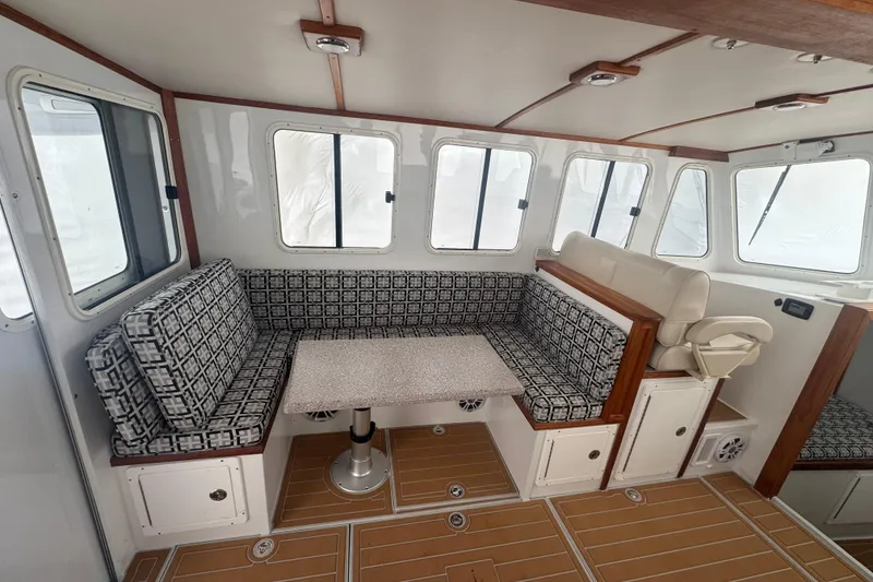 Slide: The Image of Interior of 2000 Northern Bay 38, featuring patterned seating and a compact table. - 7