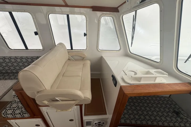 Slide: The Image of Interior of 2000 Northern Bay 38 boat with beige seating and large windows. - 8