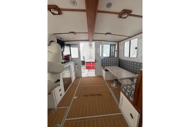 Slide: The Image of Interior of 2000 Northern Bay 38 boat with seating and kitchenette. - 9