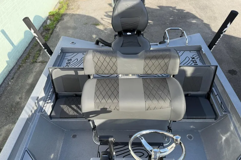 Slide: The Image of 2026 Xpress H22B Bay boat interior with sleek seating and steering wheel. - 10