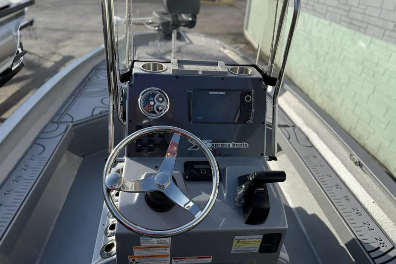 Slide: The Image of 2026 Xpress H22B Bay boat dashboard with steering wheel and navigation system. - 12