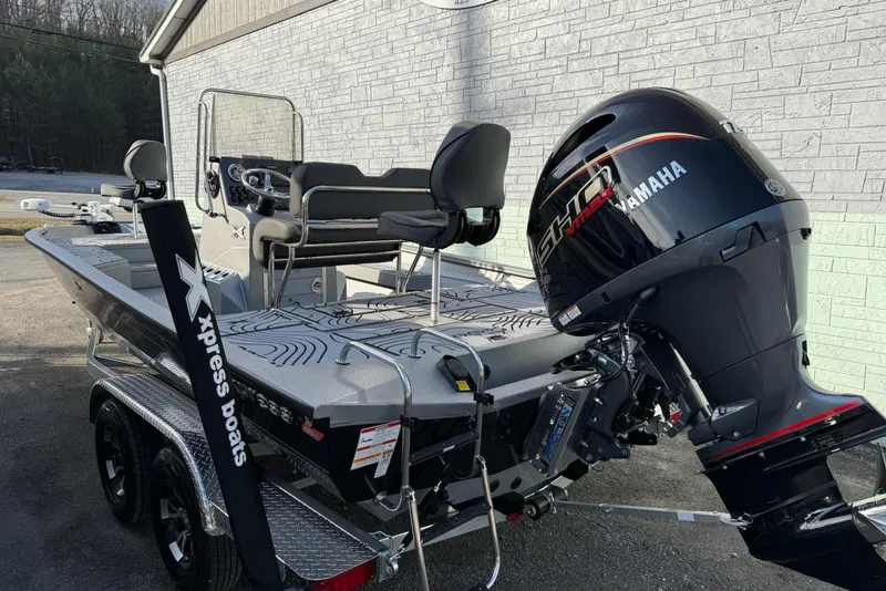 Slide: The Image of 2026 Xpress H22B Bay boat with Yamaha engine, parked on a trailer. - 5