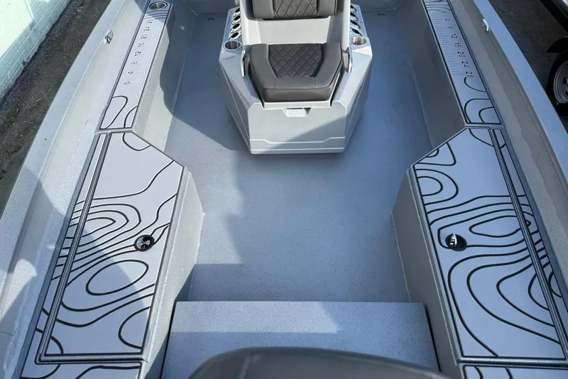 Slide: The Image of 2026 Xpress H22B Bay boat interior with patterned storage compartments and cushioned seating. - 7
