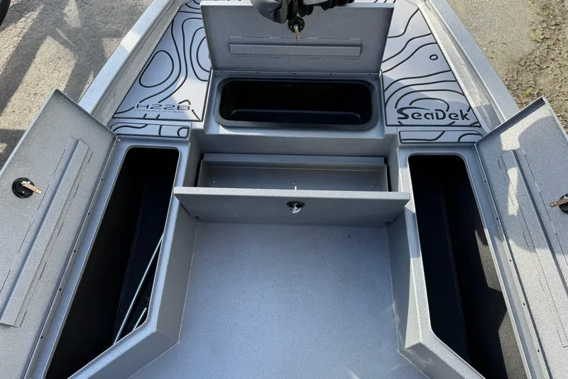 Slide: The Image of 2026 Xpress H22B Bay boat storage compartments with SeaDek flooring. - 9