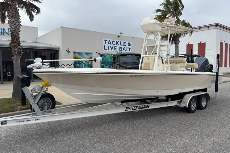 The Image of 2014 Pathfinder 2600 HPS boat on trailer outside tackle shop. - 1