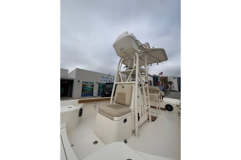 Slide: The Image of 2014 Pathfinder 2600 HPS boat with seating and T-top, docked near tackle shop. - 4