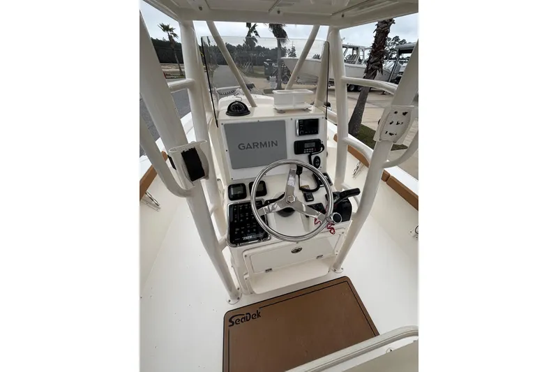 Slide: The Image of 2014 Pathfinder 2600 HPS boat console with Garmin navigation system and steering wheel. - 8