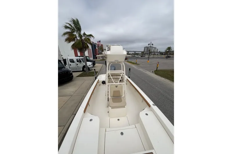 Slide: The Image of 2014 Pathfinder 2600 HPS boat docked near palm trees and vehicles. - 9
