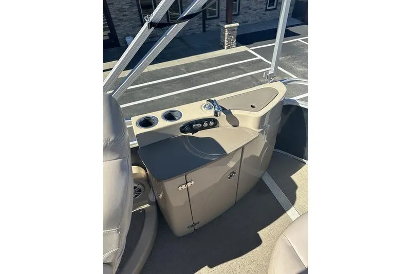 Slide: The Image of 2015 Regency 220 DL3 boat console with cup holders and storage cabinet. - 16