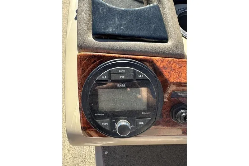 Slide: The Image of Dashboard of 2015 Regency 220 DL3 with Boss audio system and wood paneling. - 17