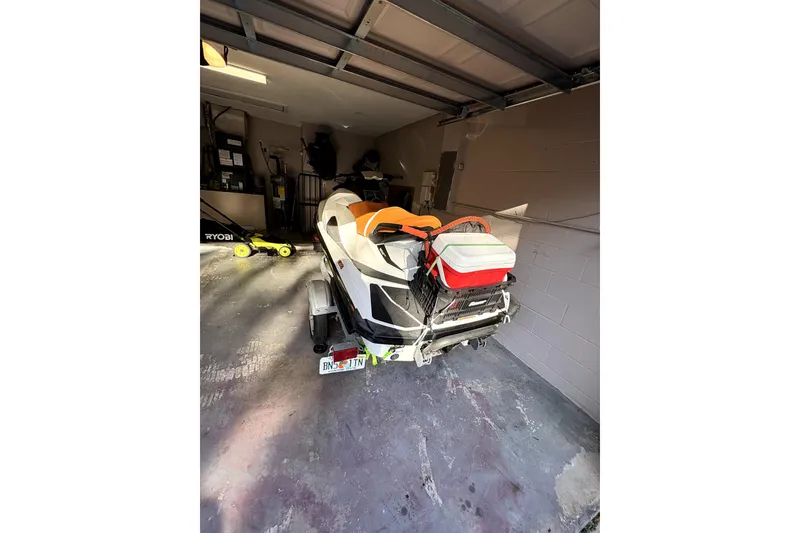 Slide: The Image of 2015 Sea-Doo GTS 130 jet ski in garage, rear view with trailer. - 3