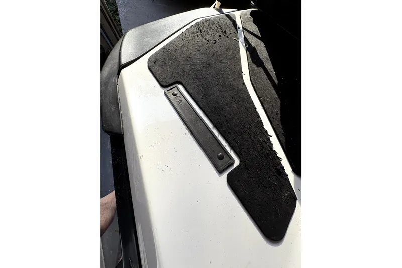 Slide: The Image of 2015 Sea-Doo GTS 130 with worn black traction mats on white surface. - 6