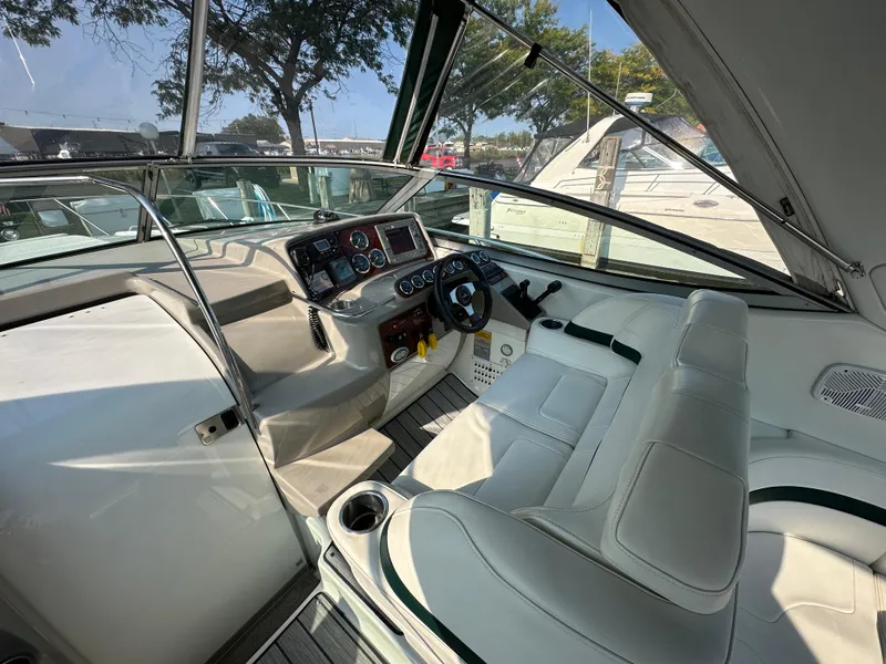 Slide: The Image of 2004 Formula 34 PC boat cockpit with steering wheel and dashboard, featuring white seating and controls. - 10