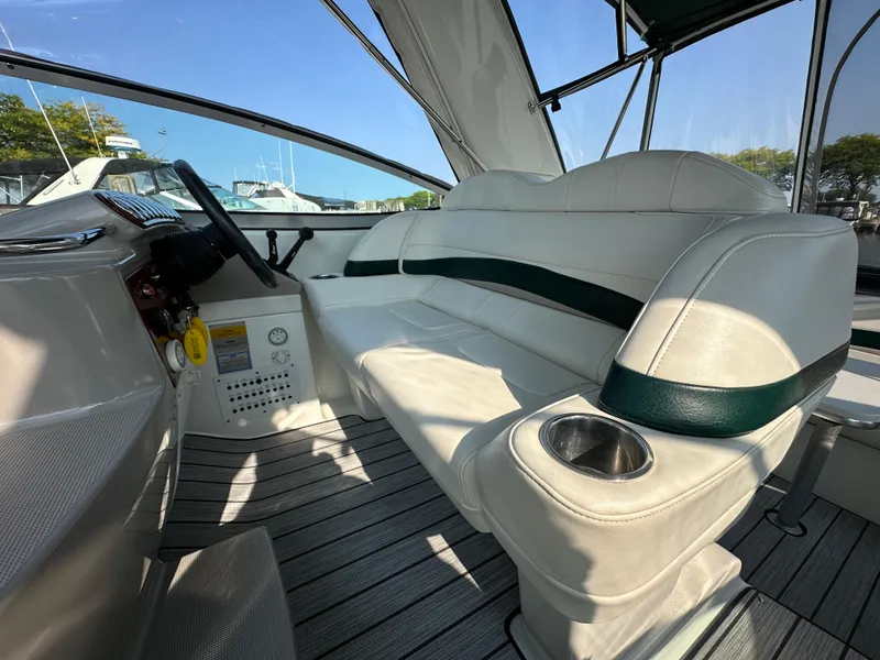 Slide: The Image of 2004 Formula 34 PC boat interior with white seating and cup holder. - 11