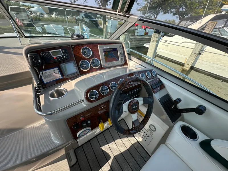 Slide: The Image of 2004 Formula 34 PC boat dashboard with gauges and controls, docked at marina. - 12