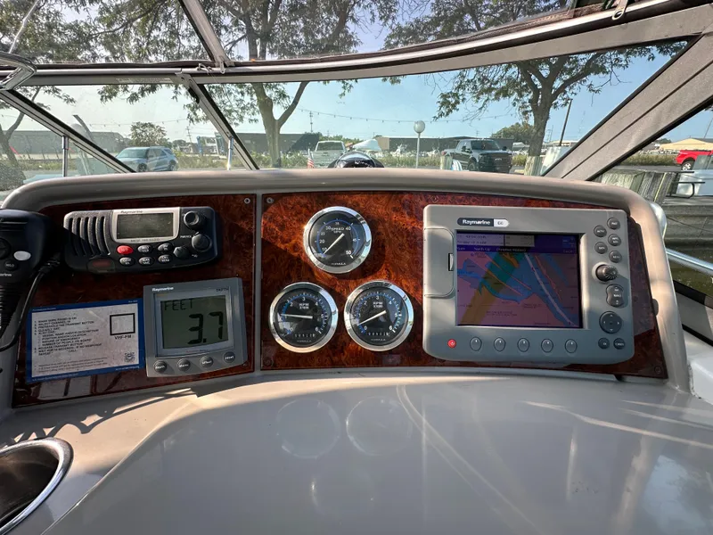 Slide: The Image of 2004 Formula 34 PC dashboard with navigation system and gauges in a marina setting. - 13