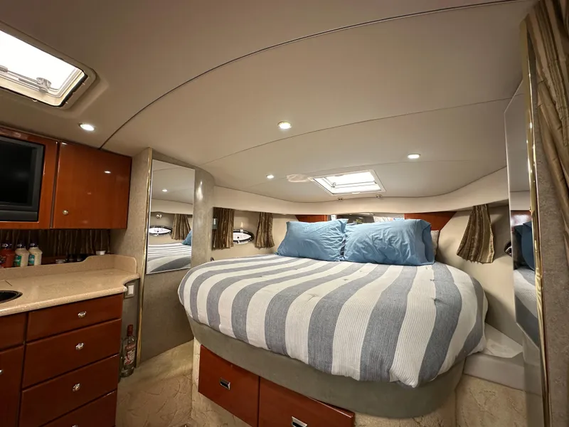 Slide: The Image of Luxurious cabin interior of 2004 Formula 34 PC yacht with cozy bed and elegant wood cabinetry. - 22