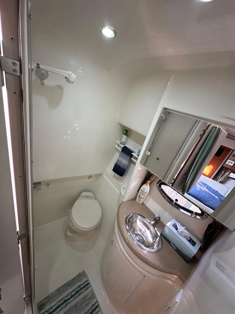 Slide: The Image of 2004 Formula 34 PC yacht bathroom with sink, toilet, and mirror. - 23